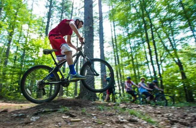 boy riding a trail bike in the woods