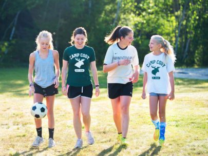 four girls in soccer gear walking
