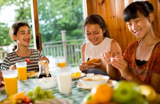 three girls eating breakfast