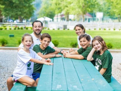 camp directors with kids at a picnic table