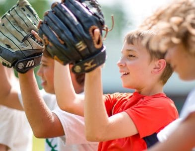 boys with baseball gloves ready to catch the ball