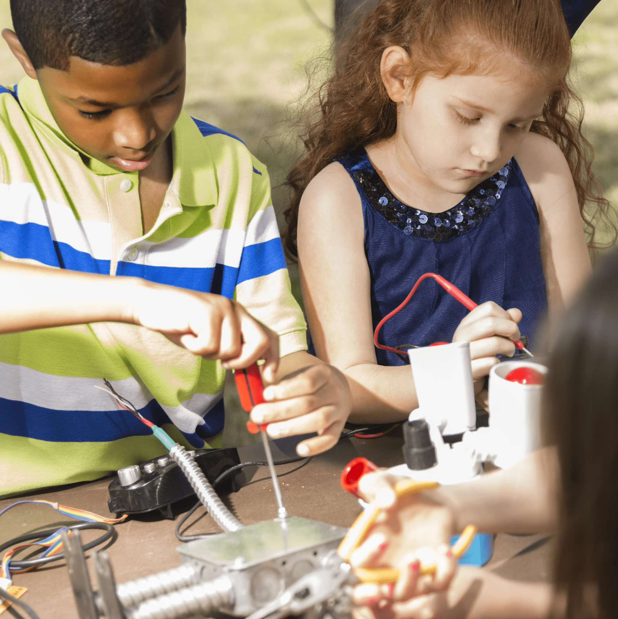 boy and girl camper screwing electric things in