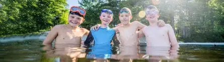 four young boys in a lake