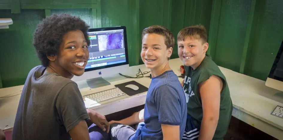 three boys in front of a computer