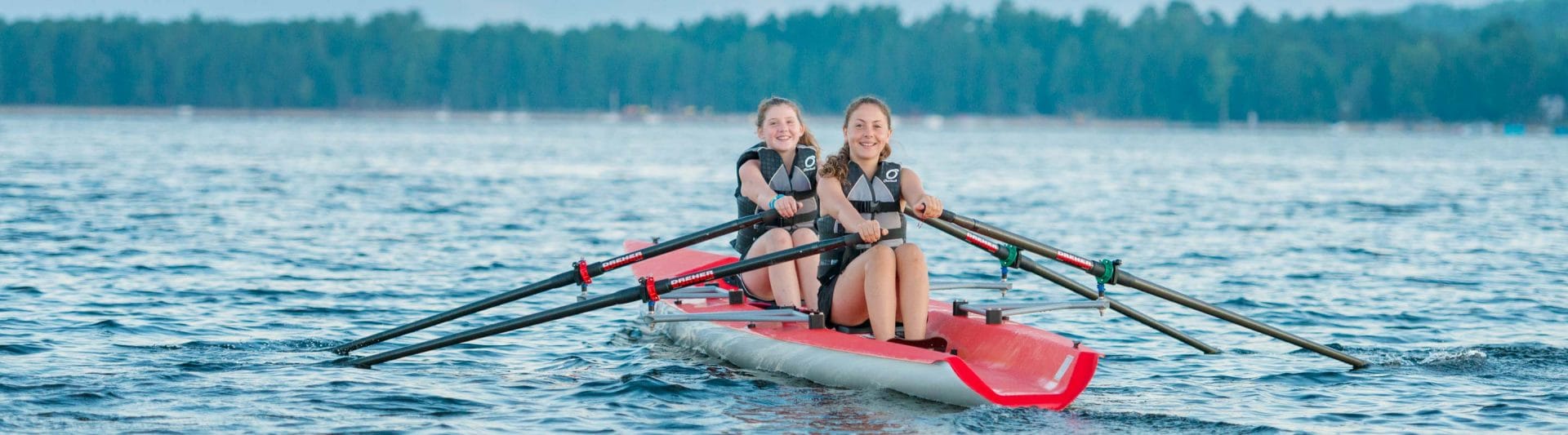 girls rowing in a canoe