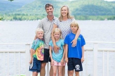 family standing in front of Ossipee Lake