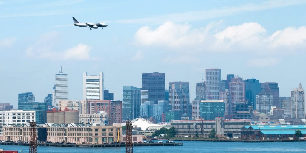 plane flying over the city of Boston