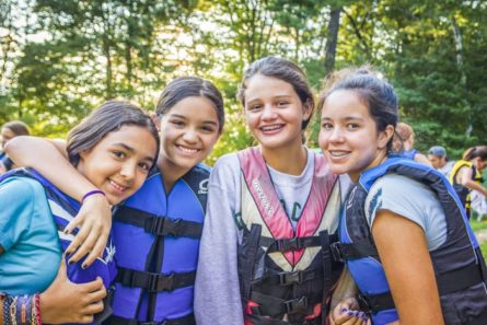 group of girls at summer camp in life vests