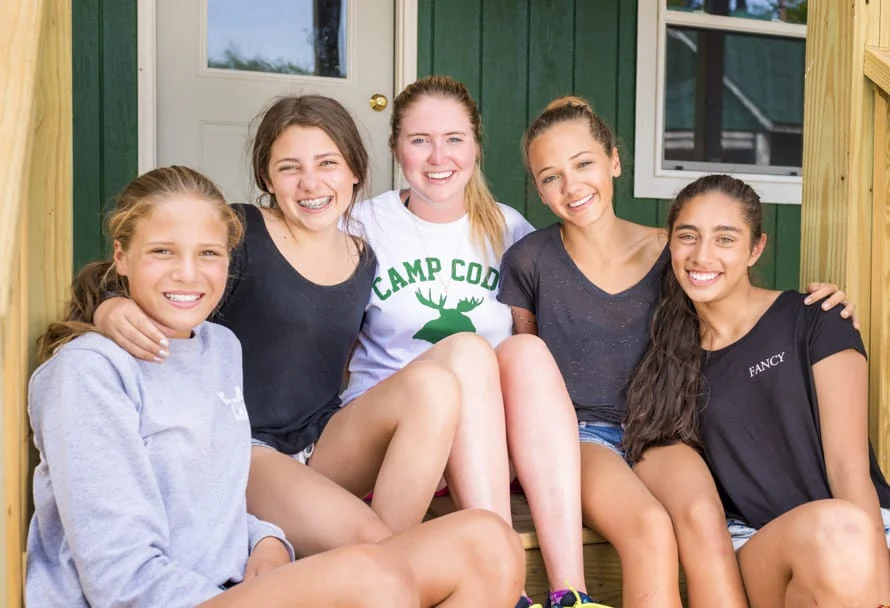 a group of young girls smiling and having fun together