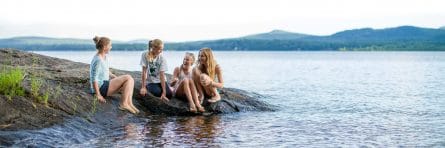 girls on a rock near the lake