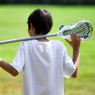 boy holding a lacrosse stick