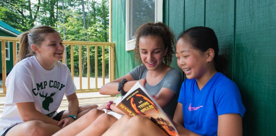 girls reading books and laughing