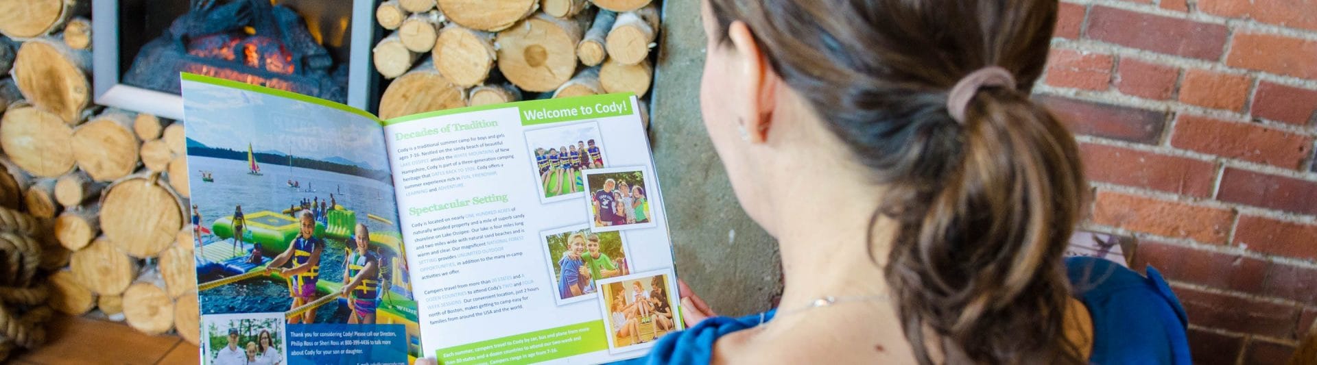 girl reading brochure for camp cody