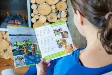 girl reading camp cody brochure