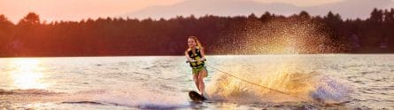 girl wakeboarding at sunset
