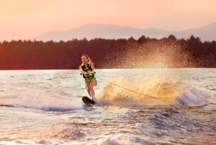 girl wakeboarding at sunset