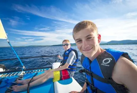 two cool boys chilling on a sailboat