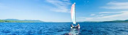 campers on a sailboat on a beautiful clear day and lake