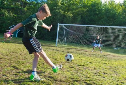 kids playing soccer at summer camp