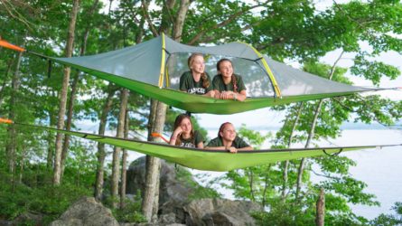 girls relaxing in hammocks above the ground