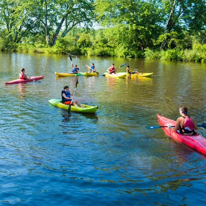 campers kayaking on a river