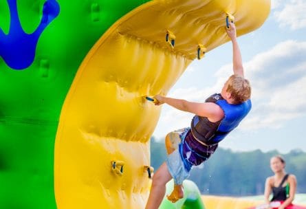 boy climbing raft