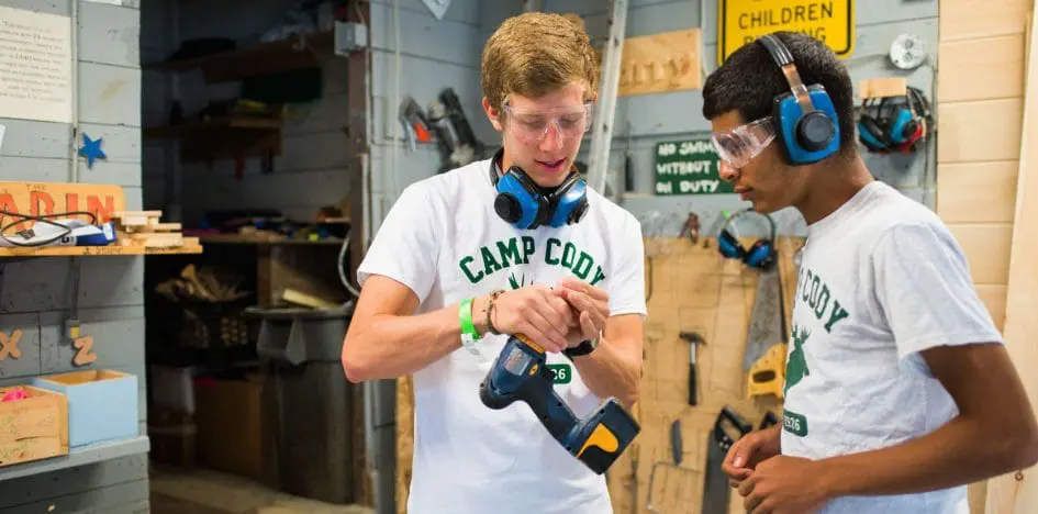 boys playing with an electric screwdriver