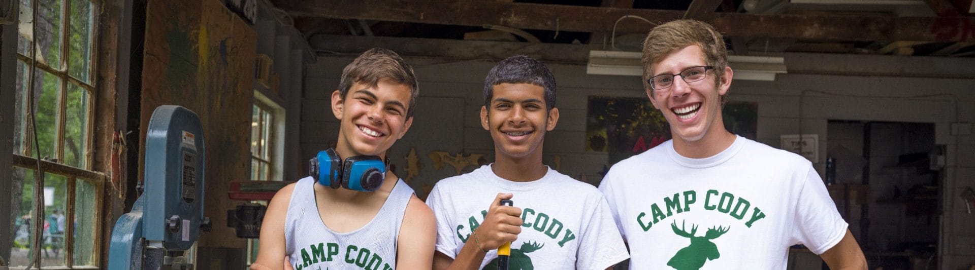 three guys smiling at the camera