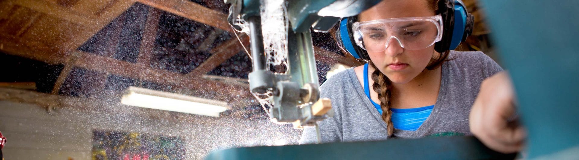 girl focusing on woodworking