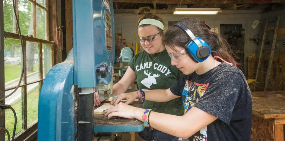 two girls wood working