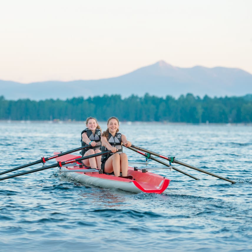 two girls kayaking in lake