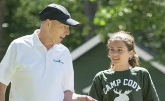 an old man talking to a young girl