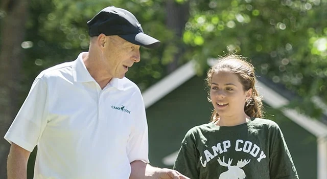 an old man talking to a young girl