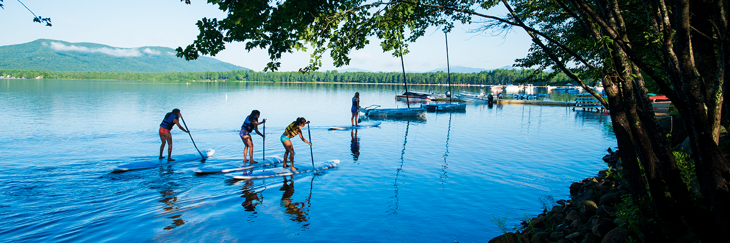 a group of people paddle boarding