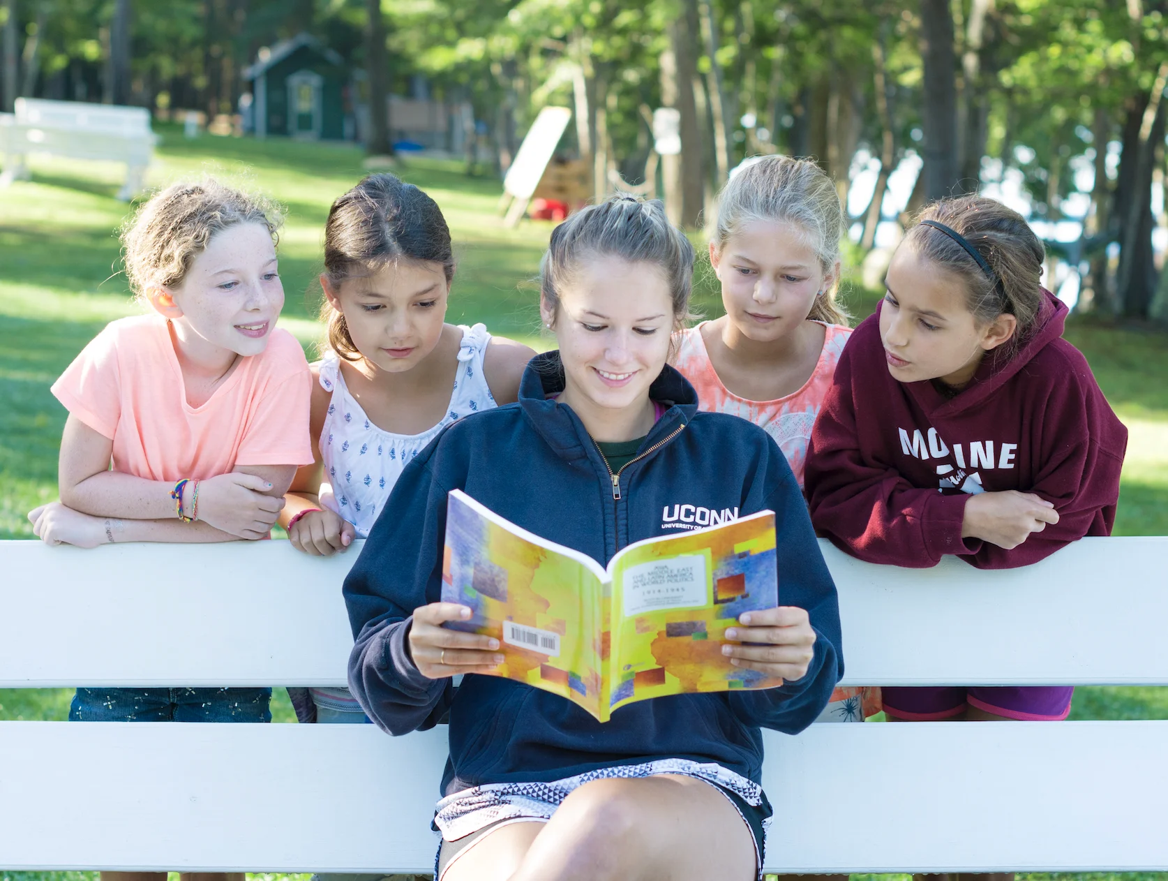camp counselor reading to campers