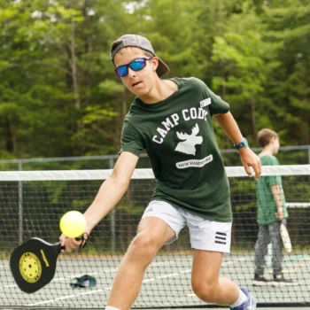 boy playing pickleball.