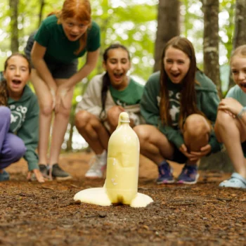 teens performing science experiment.