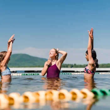 two girls receiving swim lessons.
